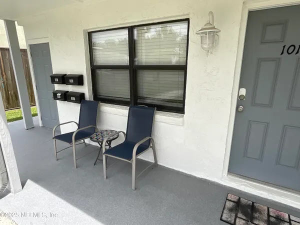 a dining room with furniture and a window