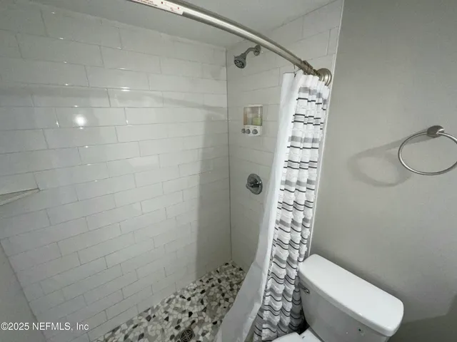a bathroom with a shower and a toilet