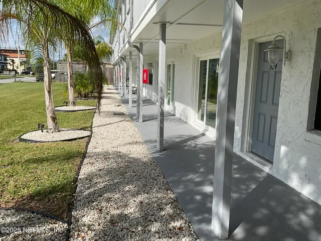 a view of a porch with chairs and table