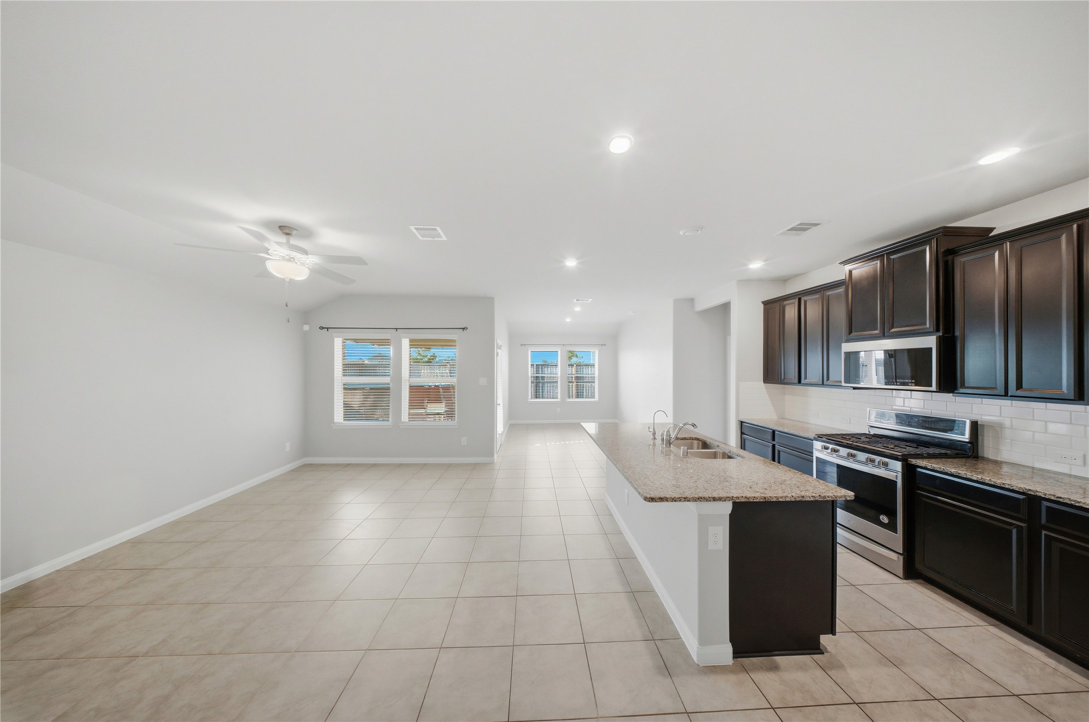 815 Barstow Drive Rosharon, TX 77583 - Photo 3 of 23 Open-concept kitchen and living area with abundant natural light and seamless flow