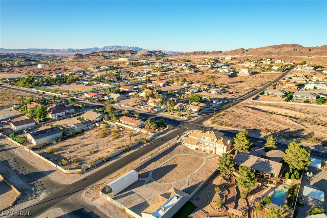 640 North Racetrack Road Henderson, NV 89015 - Photo 6 of 65 An aerial perspective reveals a vibrant desert community nestled against a backdrop of distant mountains.