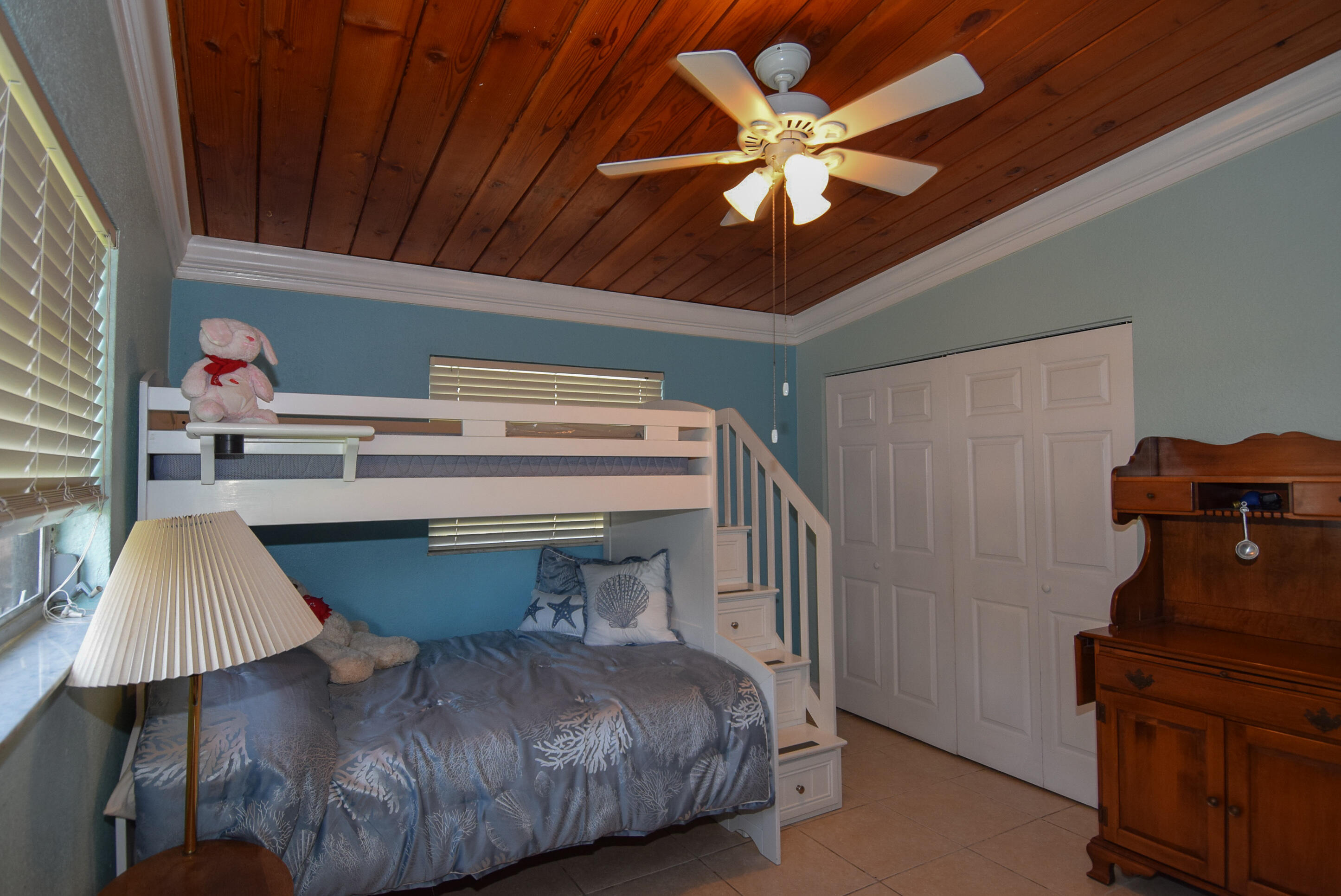 334 3rd Road Key Largo, FL 33037 - Photo 21 of 30 a bedroom with a bed and a chandelier