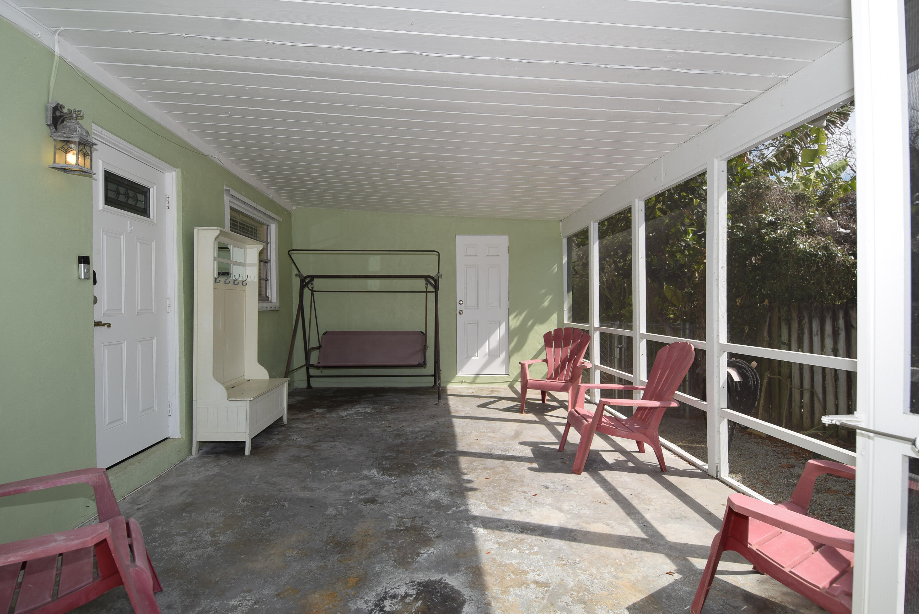 334 3rd Road Key Largo, FL 33037 - Photo 26 of 30 a view of a patio with table and chairs and floor to ceiling window