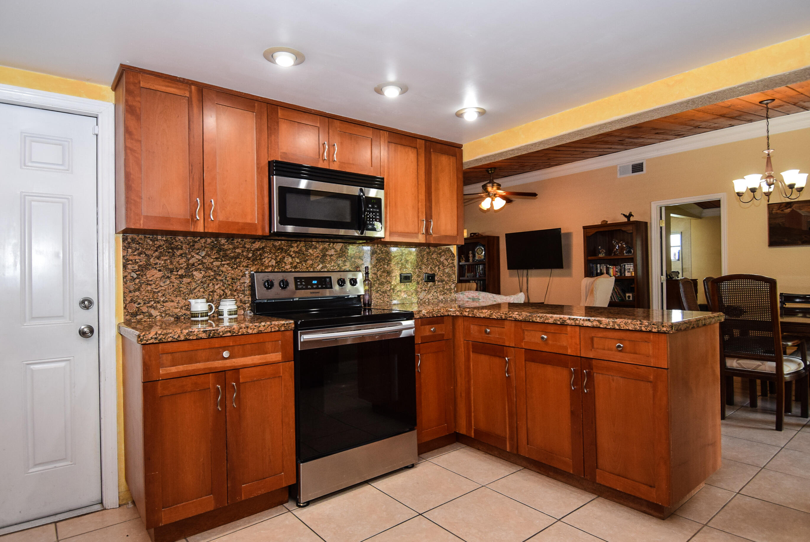 334 3rd Road Key Largo, FL 33037 - Photo 3 of 30 a kitchen with stainless steel appliances granite countertop a stove top oven a sink and a refrigerator