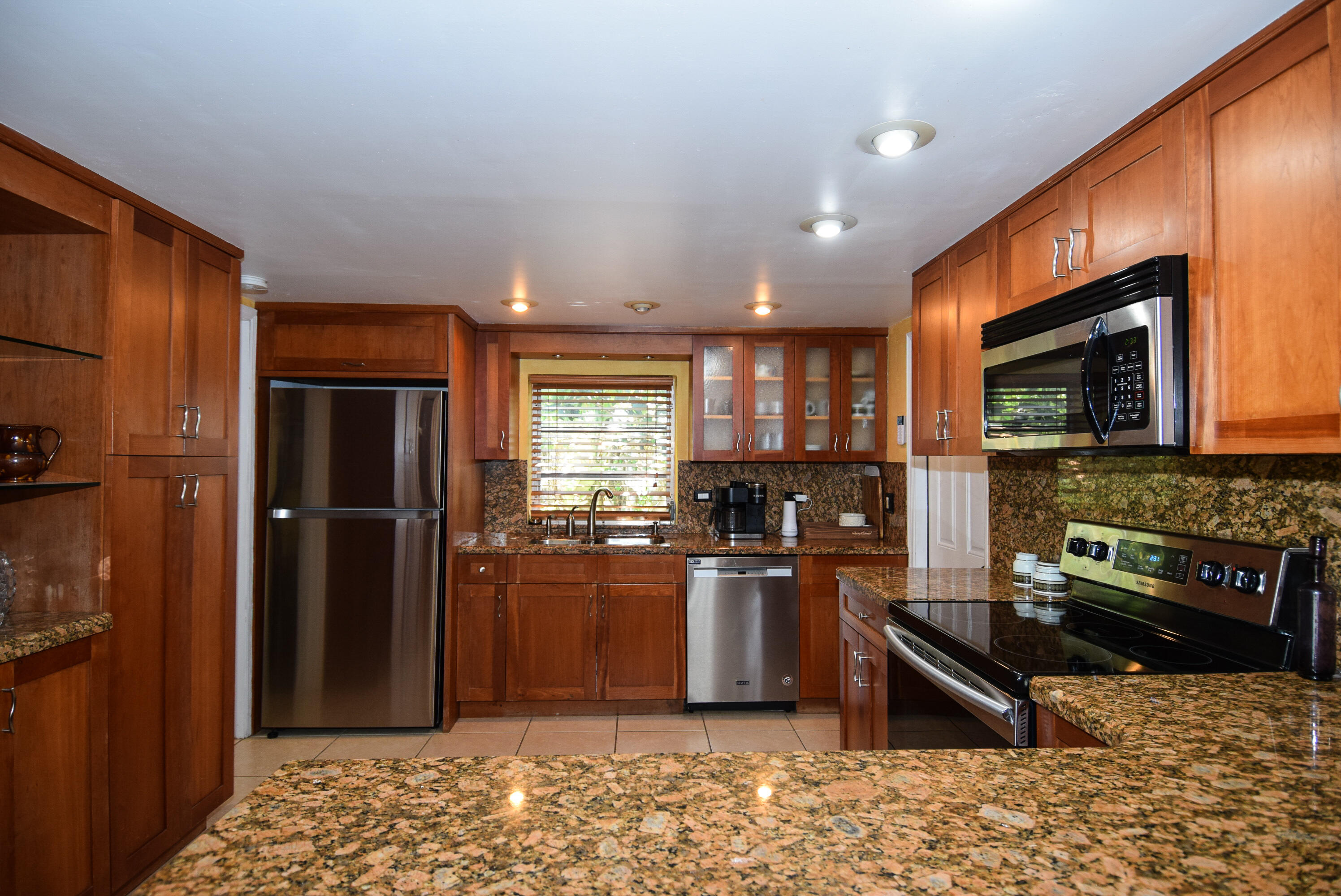 334 3rd Road Key Largo, FL 33037 - Photo 5 of 30 a kitchen with stainless steel appliances granite countertop a refrigerator stove top oven and sink