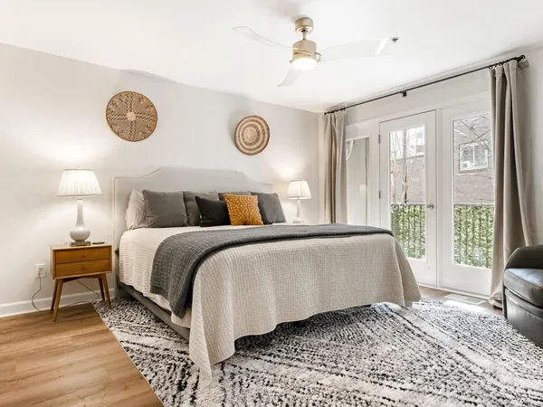 a bedroom with a bed and a lamp on table