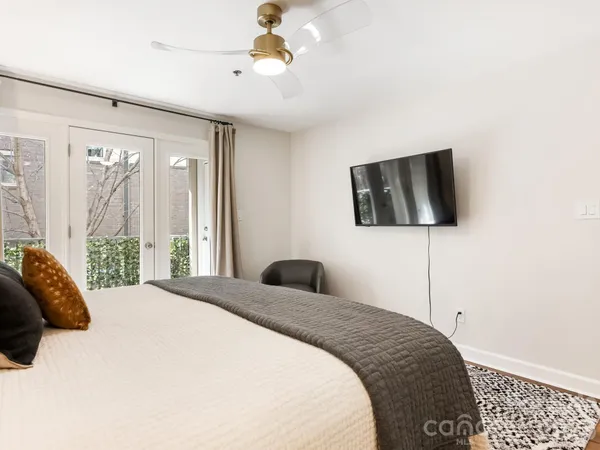 a bedroom with a bed and a flat screen tv