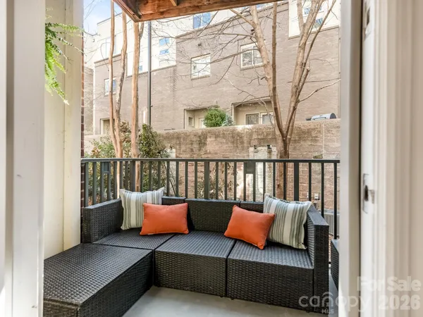 a balcony with furniture and a potted plant