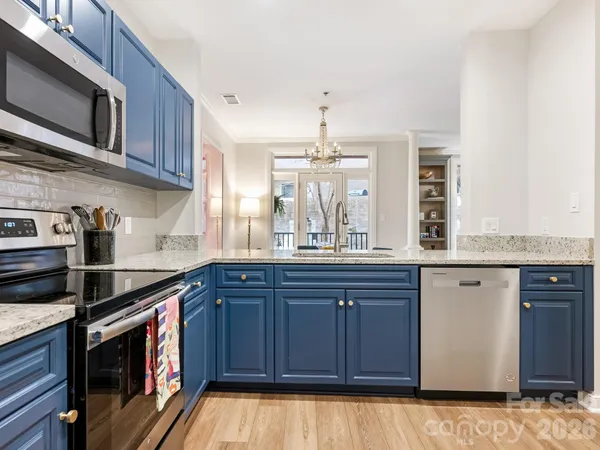 a kitchen with stainless steel appliances granite countertop a sink and stove top oven