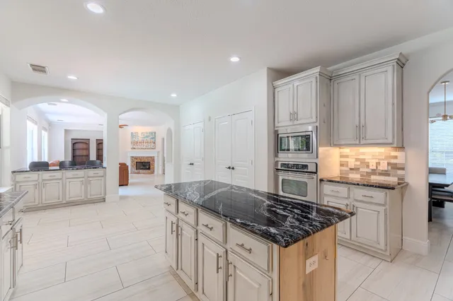 a kitchen with stainless steel appliances granite countertop a stove and a sink