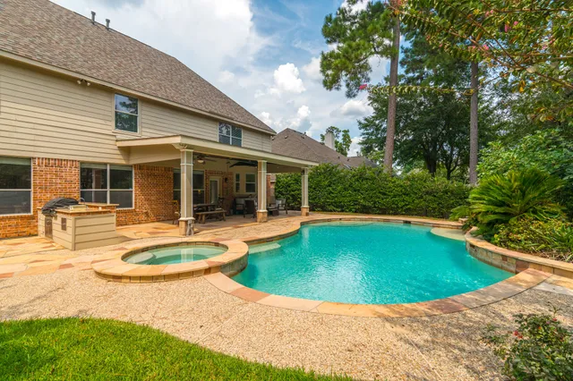 a view of a house with swimming pool and porch