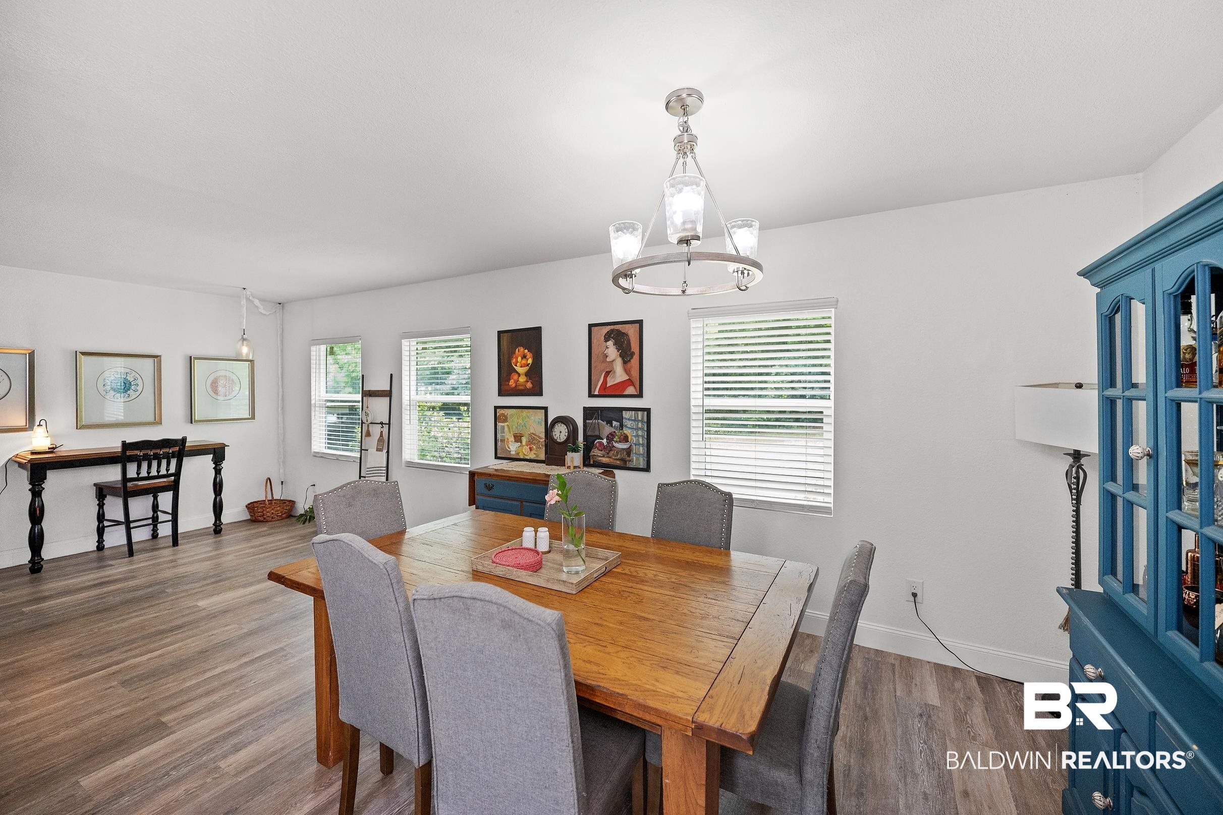 33129 Antietam Road Lillian, AL 36549 - Photo 7 of 31 Dining area featuring wood-finish flooring, white walls, and multiple windows with blinds