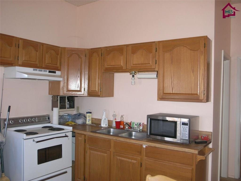 736 Upham Road Elephant Butte, NM 87935 - Photo 14 of 27 a kitchen with a stove and a microwave