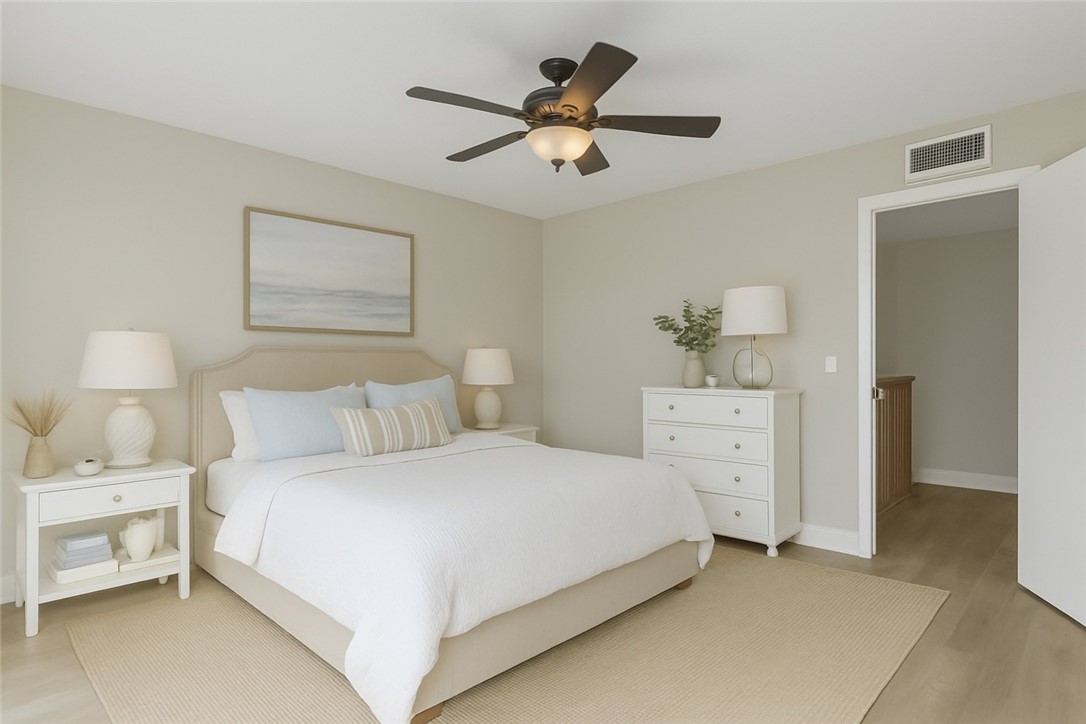 465 East Waverly Place, Unit 8B Vero Beach, FL 32960 - Photo 12 of 28 a bedroom with a bed and a chandelier