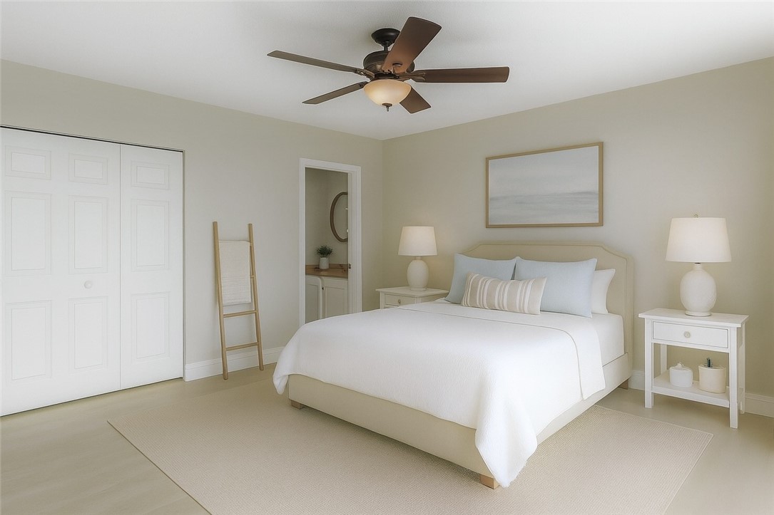 465 East Waverly Place, Unit 8B Vero Beach, FL 32960 - Photo 13 of 28 a bedroom with a bed and a ceiling fan