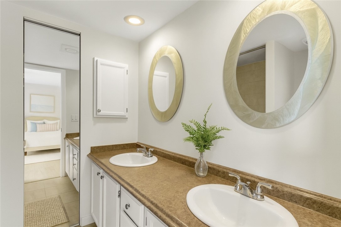 465 East Waverly Place, Unit 8B Vero Beach, FL 32960 - Photo 15 of 28 a bathroom with a sink and a mirror
