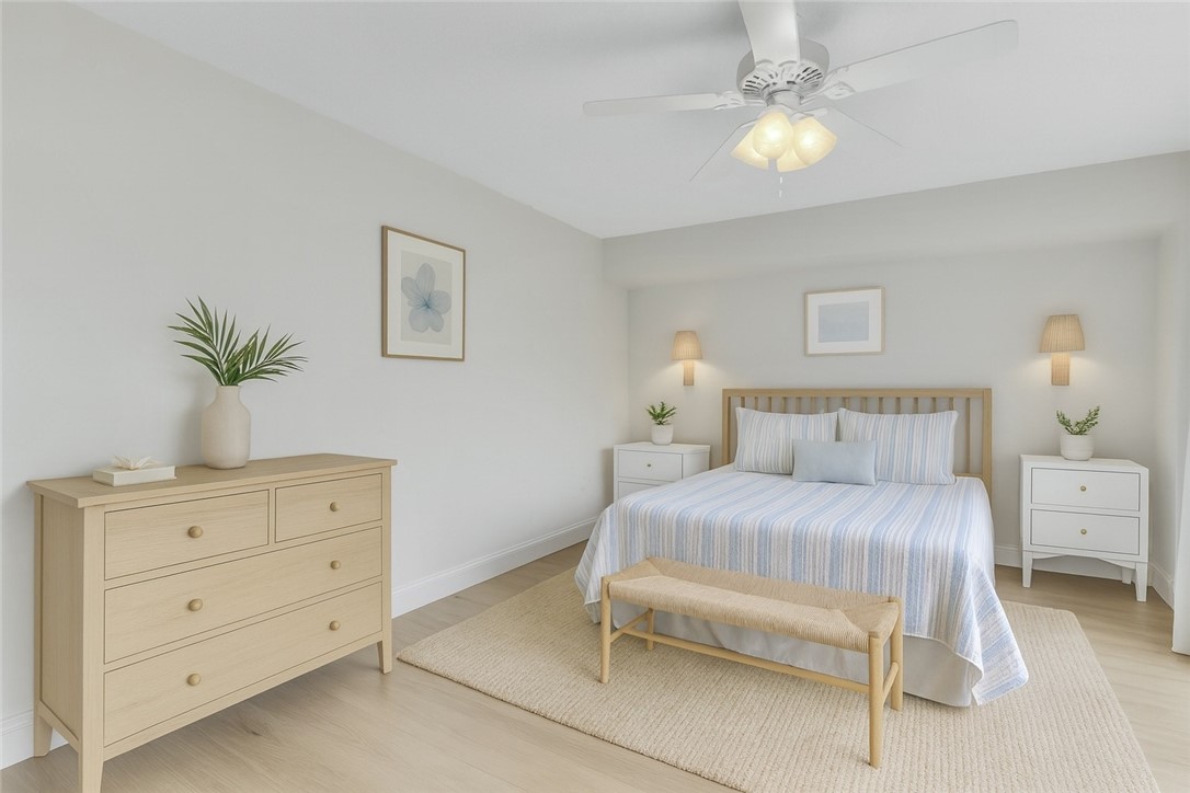 465 East Waverly Place, Unit 8B Vero Beach, FL 32960 - Photo 18 of 28 a bedroom with a large bed and a chandelier