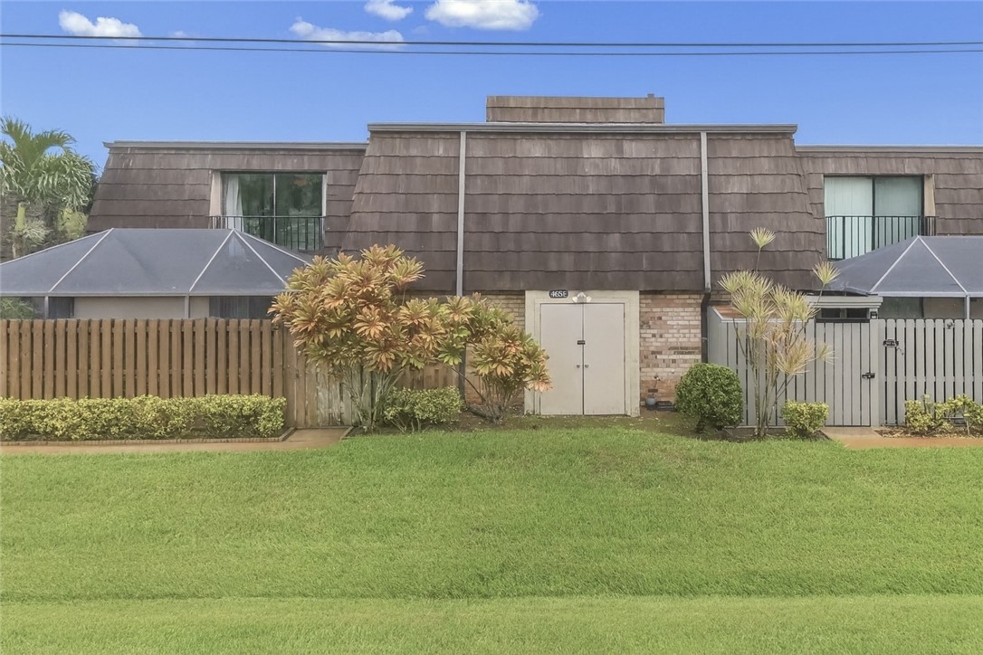 465 East Waverly Place, Unit 8B Vero Beach, FL 32960 - Photo 2 of 28 a front view of a house with garden