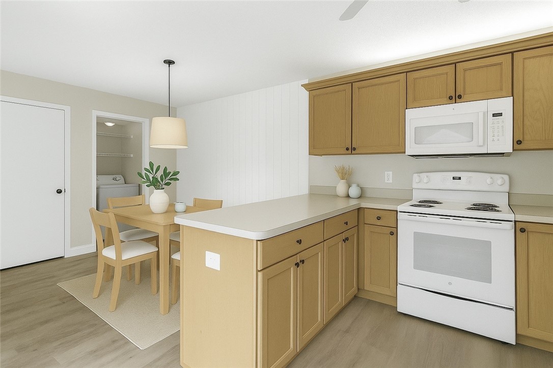465 East Waverly Place, Unit 8B Vero Beach, FL 32960 - Photo 7 of 28 a kitchen with a white cabinets and chairs