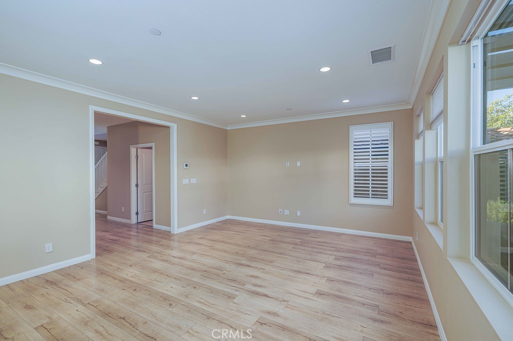 125 Waterleaf Irvine, CA 92620 - Photo 9 of 20 a view of an empty room with wooden floor and a window