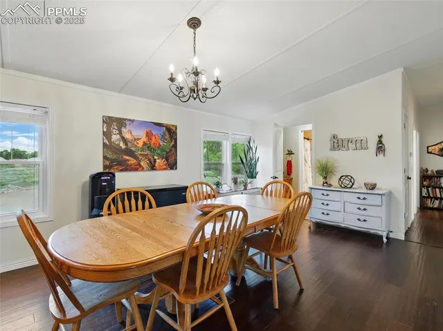 a view of a dining room with furniture wooden floor and chandelier