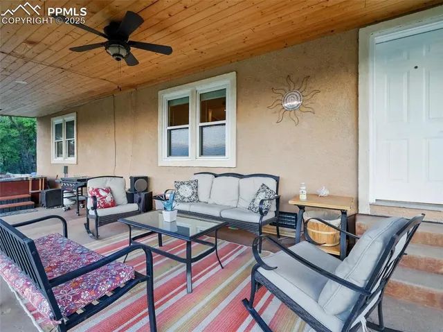 a living room with furniture and a chandelier