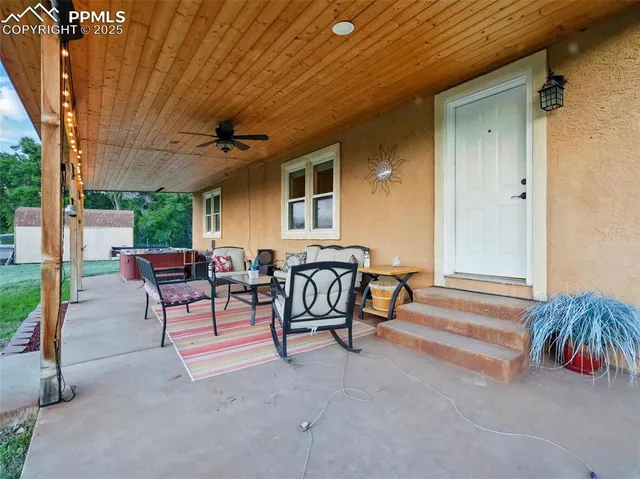a view of a house with backyard and sitting area