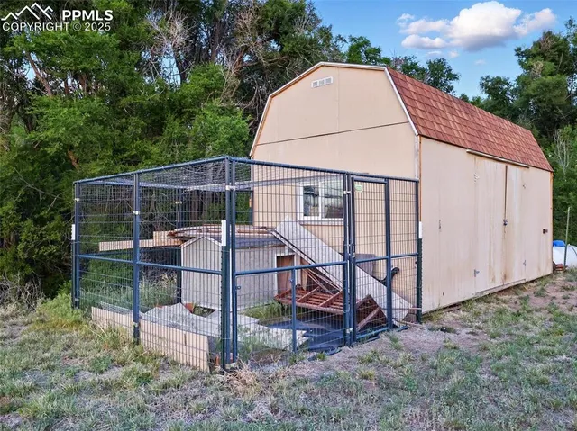 a view of backyard with outdoor seating and trees
