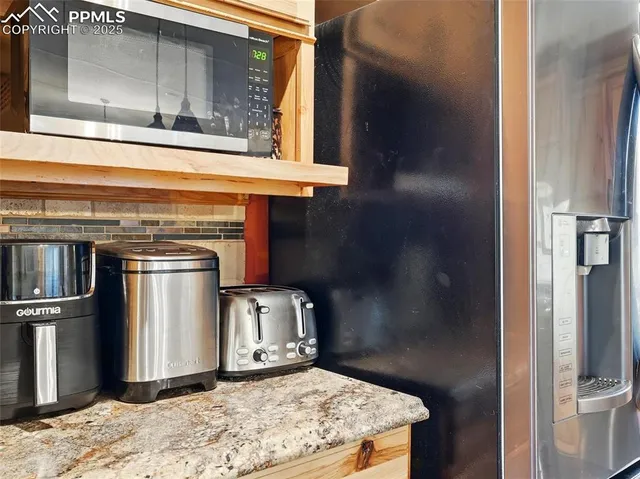 a view of a refrigerator in kitchen