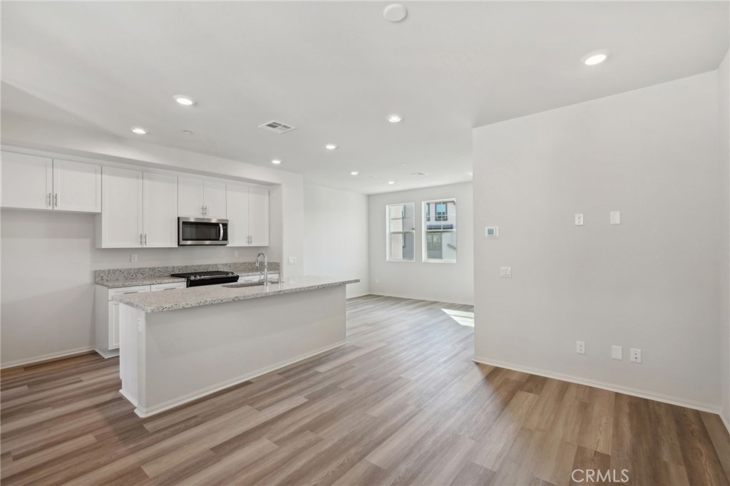 28022 Melrose Drive Temecula, CA 92591 - Photo 12 of 35 a kitchen with stainless steel appliances a sink a stove a microwave and a refrigerator