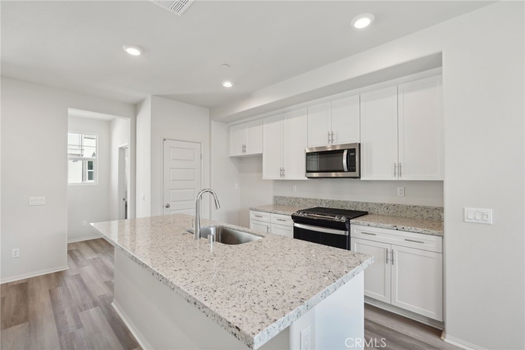 28022 Melrose Drive Temecula, CA 92591 - Photo 13 of 35 a kitchen with stainless steel appliances granite countertop a sink stove and microwave