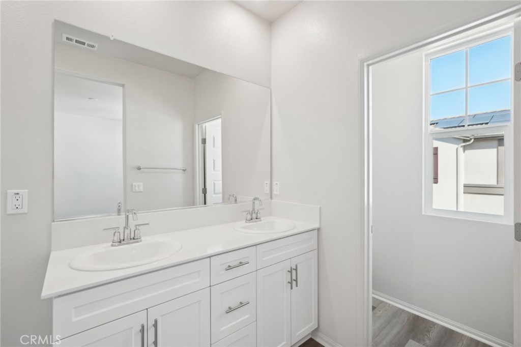 28022 Melrose Drive Temecula, CA 92591 - Photo 30 of 35 a bathroom with 2 sink and a mirror