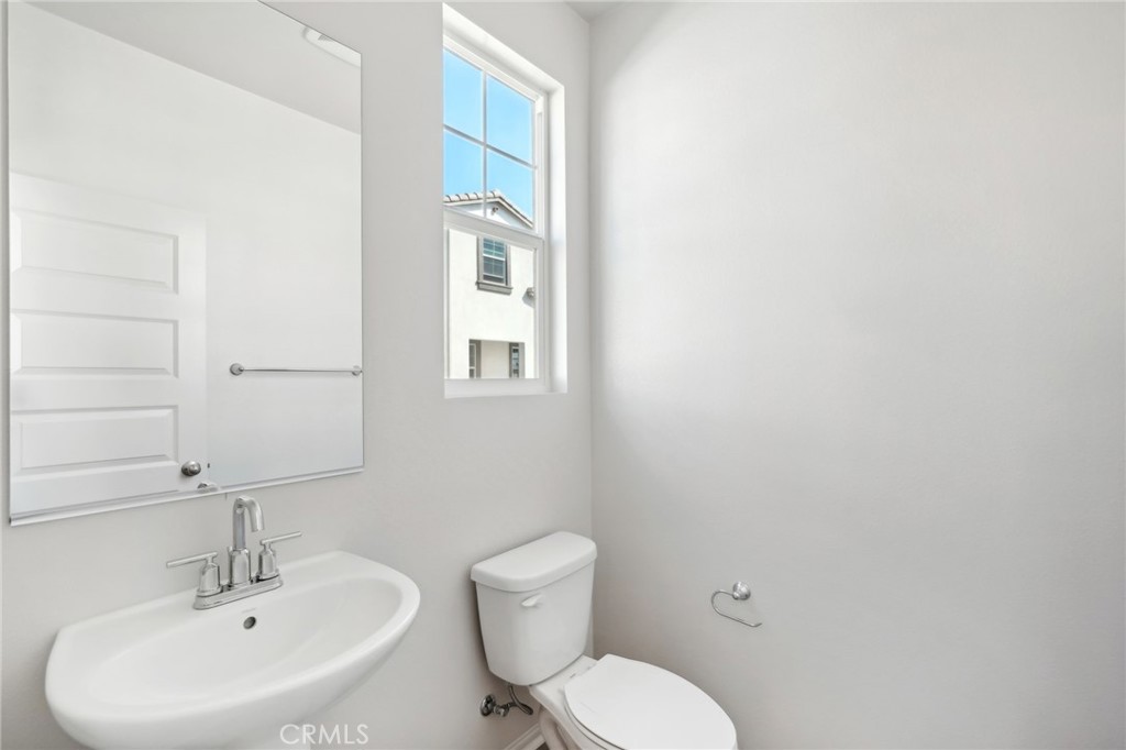 28022 Melrose Drive Temecula, CA 92591 - Photo 32 of 35 a bathroom with a toilet a sink and mirror