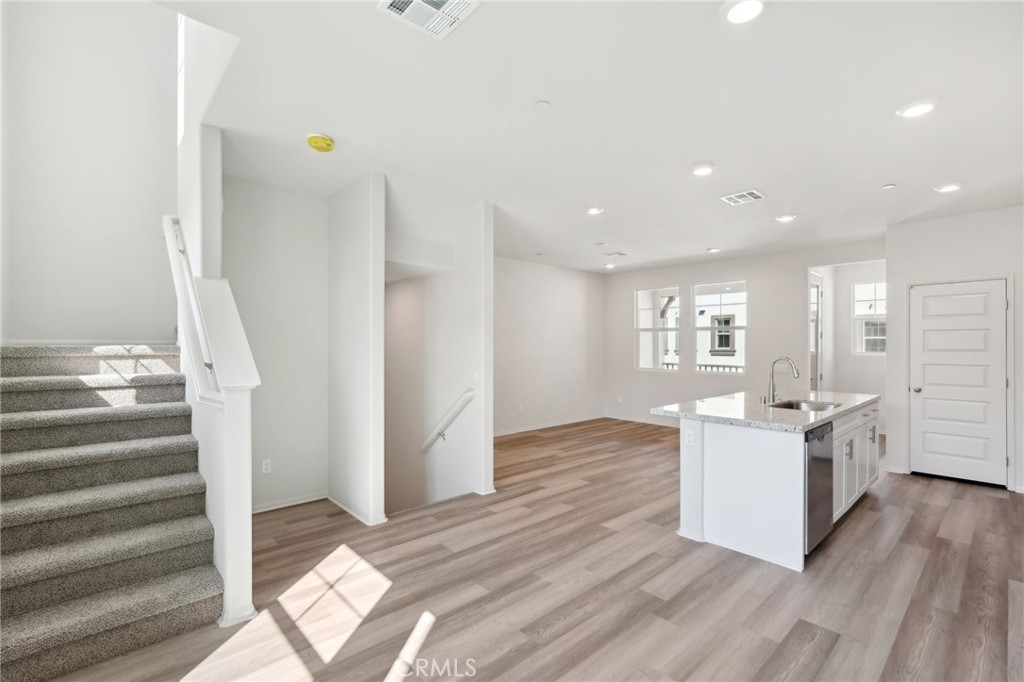 28022 Melrose Drive Temecula, CA 92591 - Photo 10 of 35 a kitchen with a sink and wooden floor