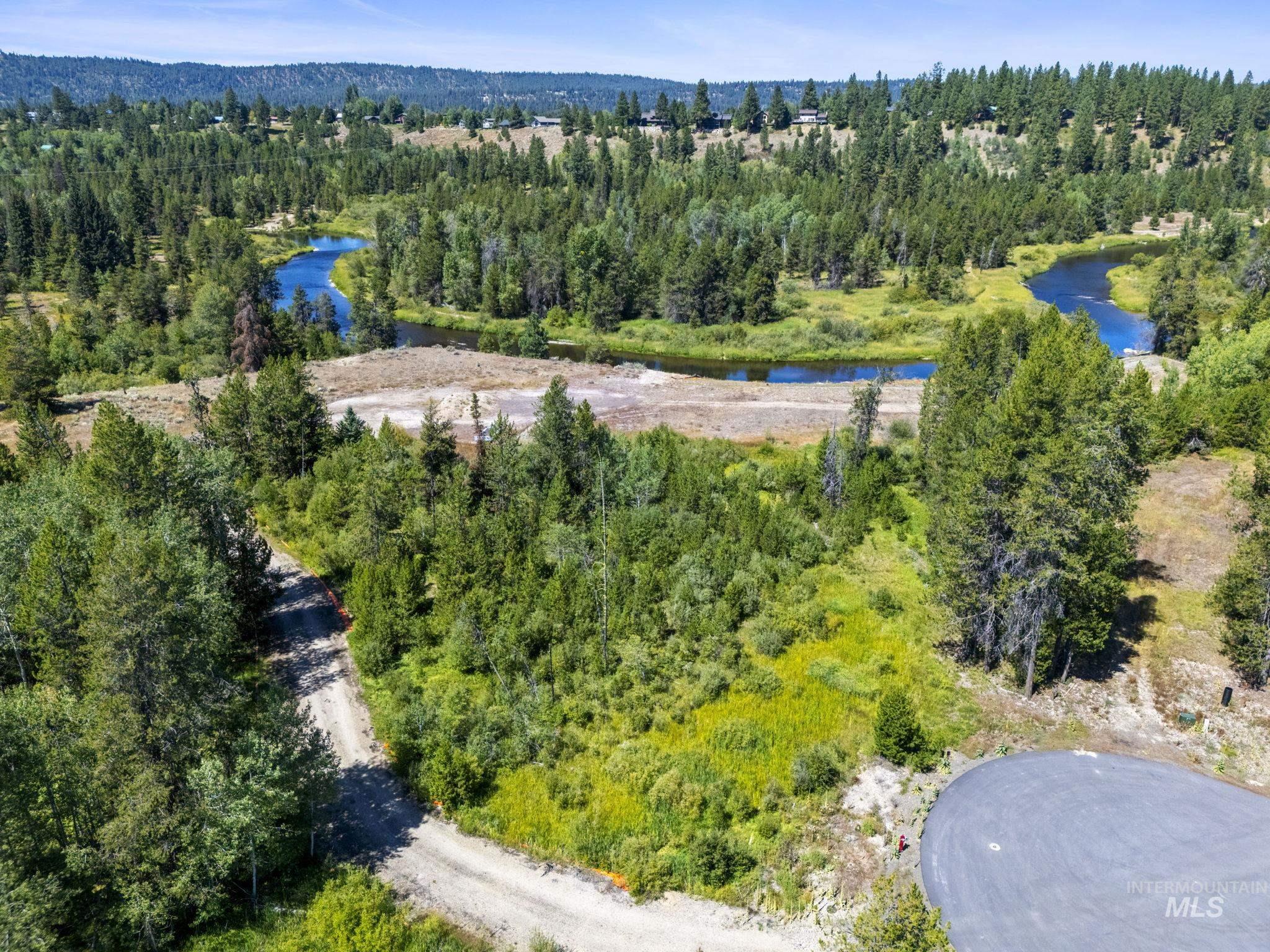 64 River Run Court McCall, ID 83638 - Photo 2 of 7 Drone / aerial view of a large body of water and a forest