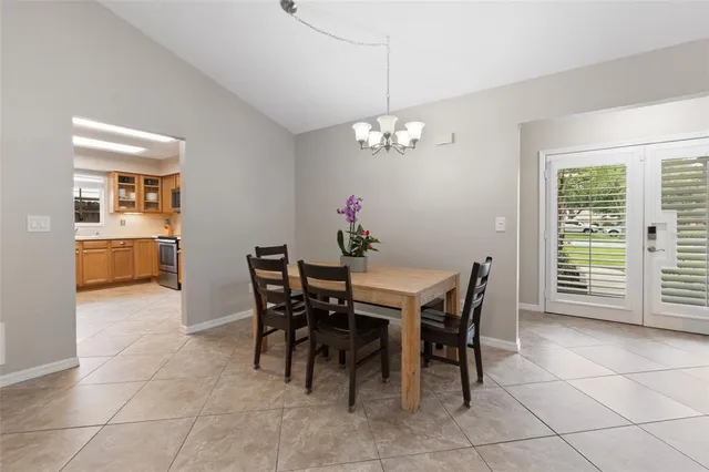 a view of a dining room with furniture and chandelier