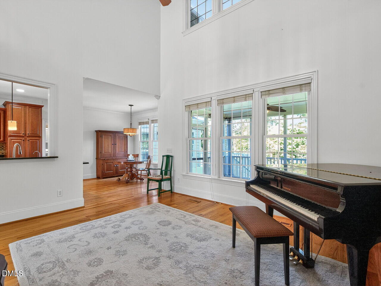 260 Marcellus Way Clayton, NC 27527 - Photo 14 of 47 a living room with furniture a table and large windows
