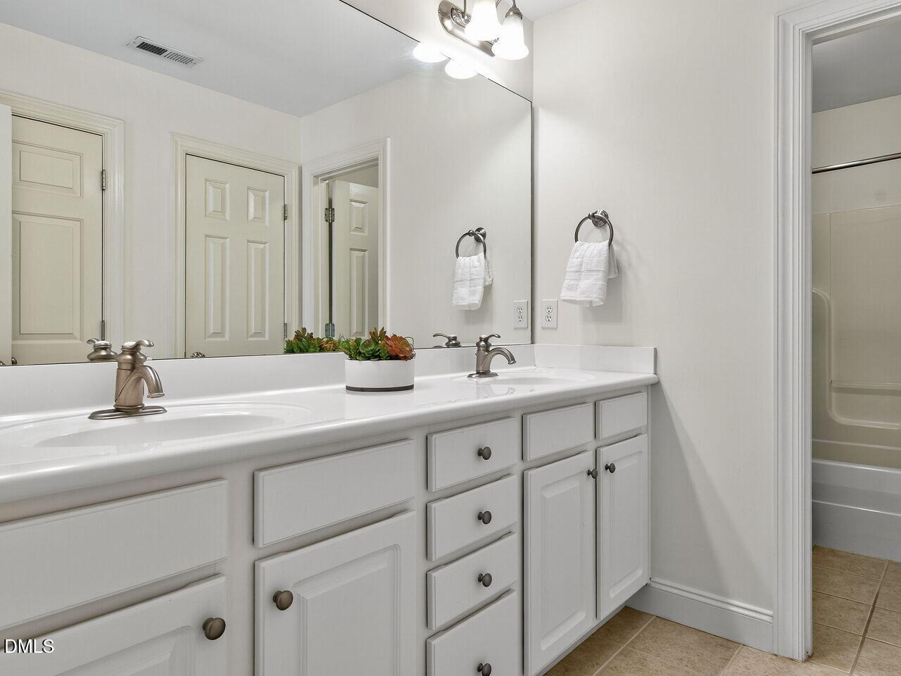 260 Marcellus Way Clayton, NC 27527 - Photo 26 of 47 a bathroom with a double vanity sink and a mirror