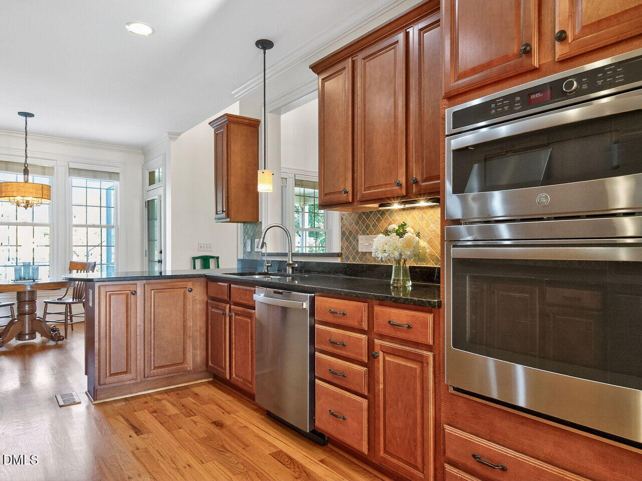 260 Marcellus Way Clayton, NC 27527 - Photo 9 of 47 a kitchen with stainless steel appliances granite countertop a stove a sink and a microwave