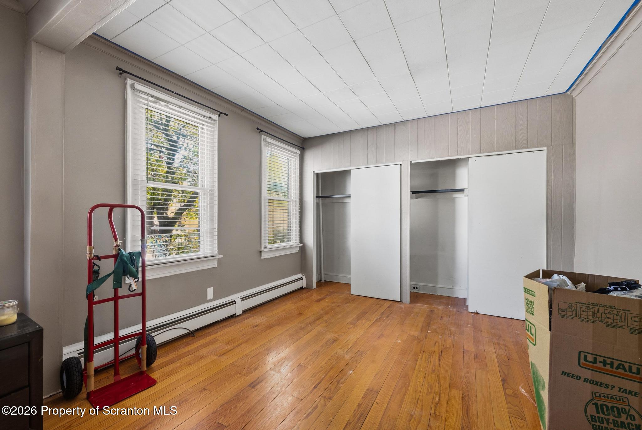 518 Prospect Avenue Scranton, PA 18505 - Photo 18 of 59 a bedroom with a bed and a tv on table
