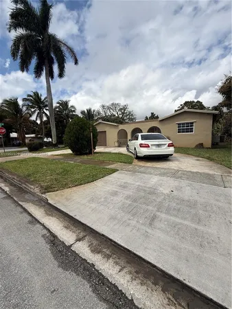 an ocean view with beach and car parked