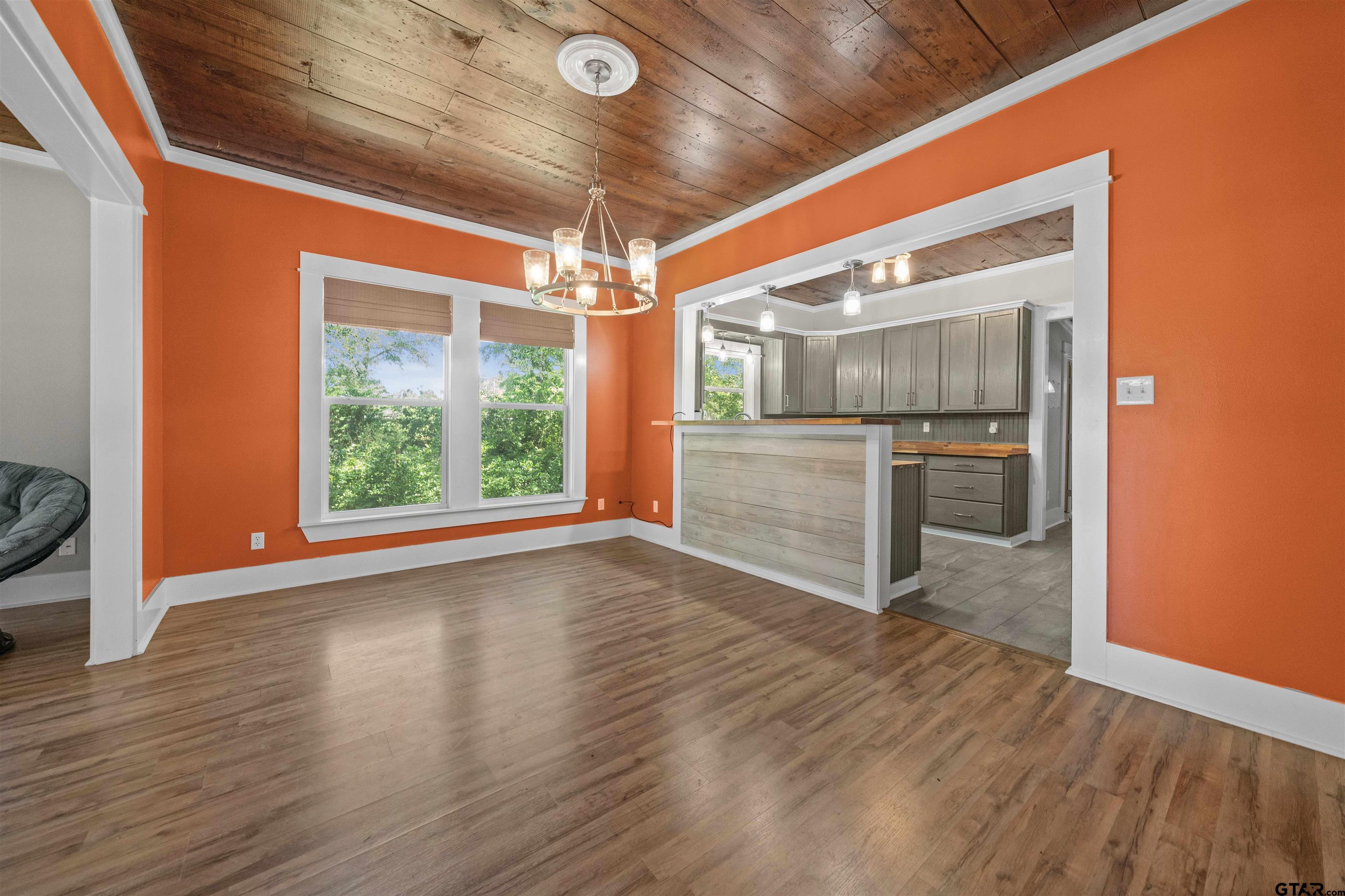 230 North Henderson Street Rusk, TX 75785 - Photo 11 of 34 a view of an empty room with wooden floor kitchen view and a fireplace