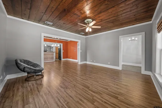 a view of livingroom with lounge chair and wooden floor