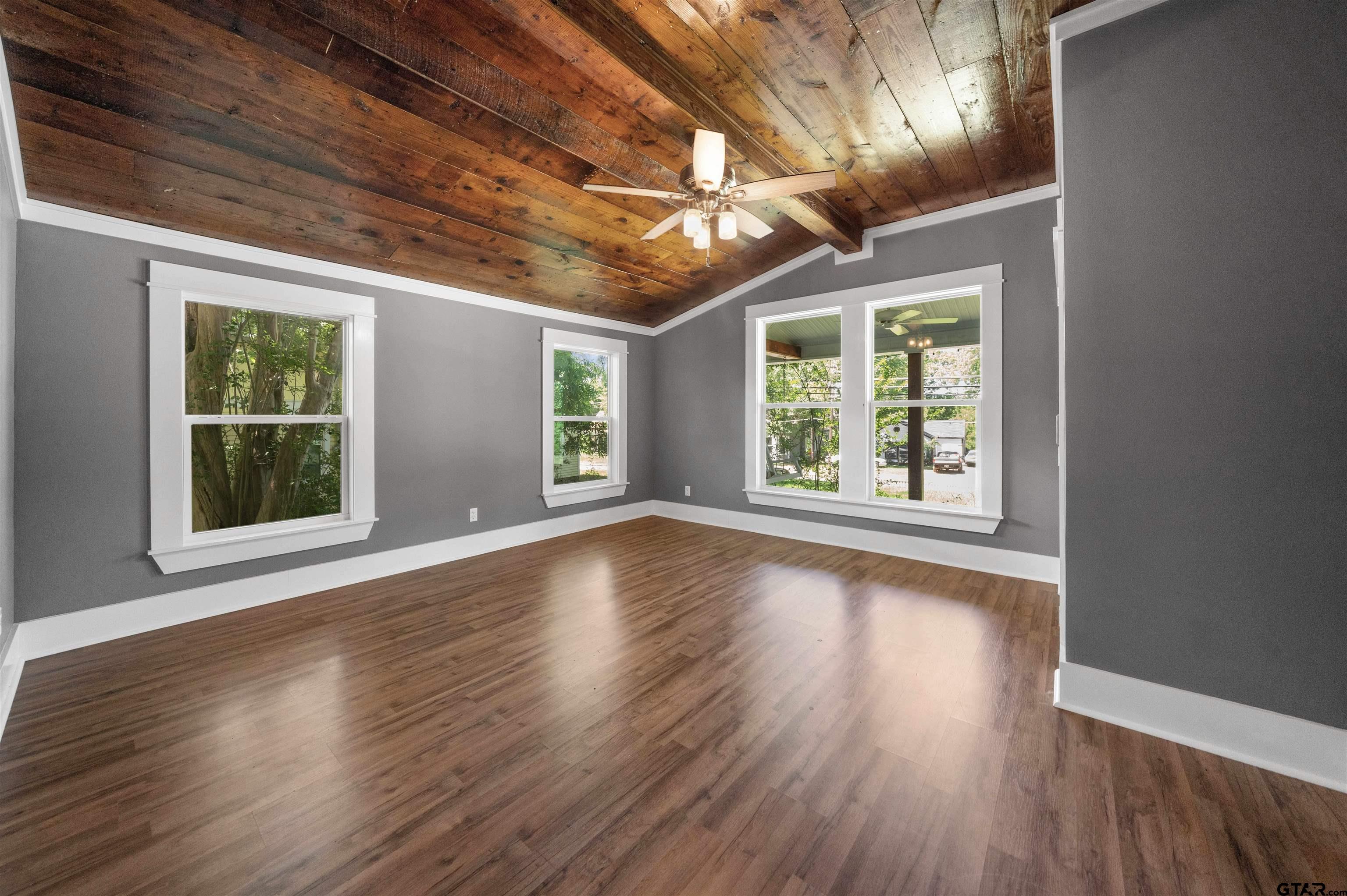 230 North Henderson Street Rusk, TX 75785 - Photo 21 of 34 an empty room with wooden floor and windows