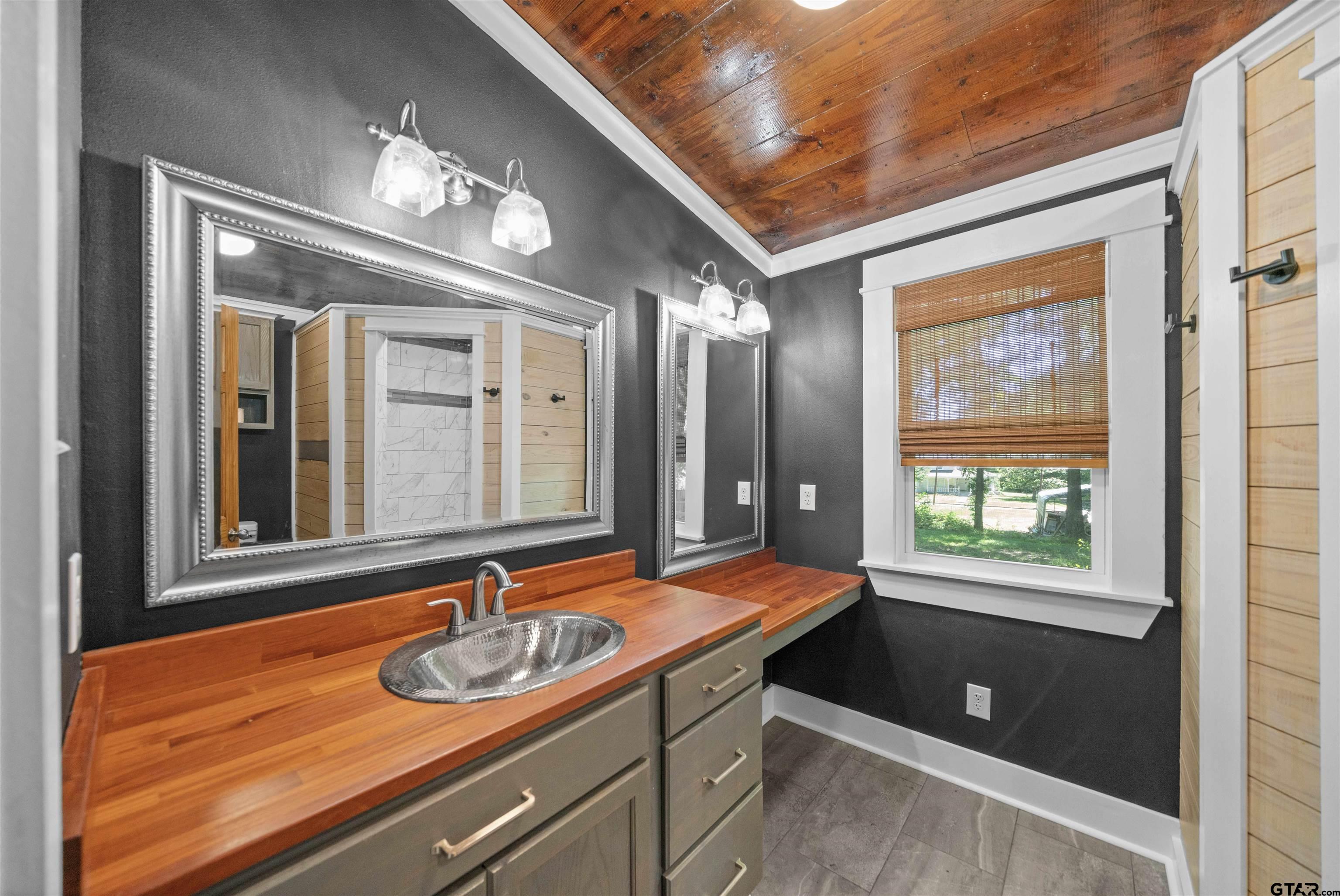 230 North Henderson Street Rusk, TX 75785 - Photo 23 of 34 a bathroom with a sink a large mirror and a window