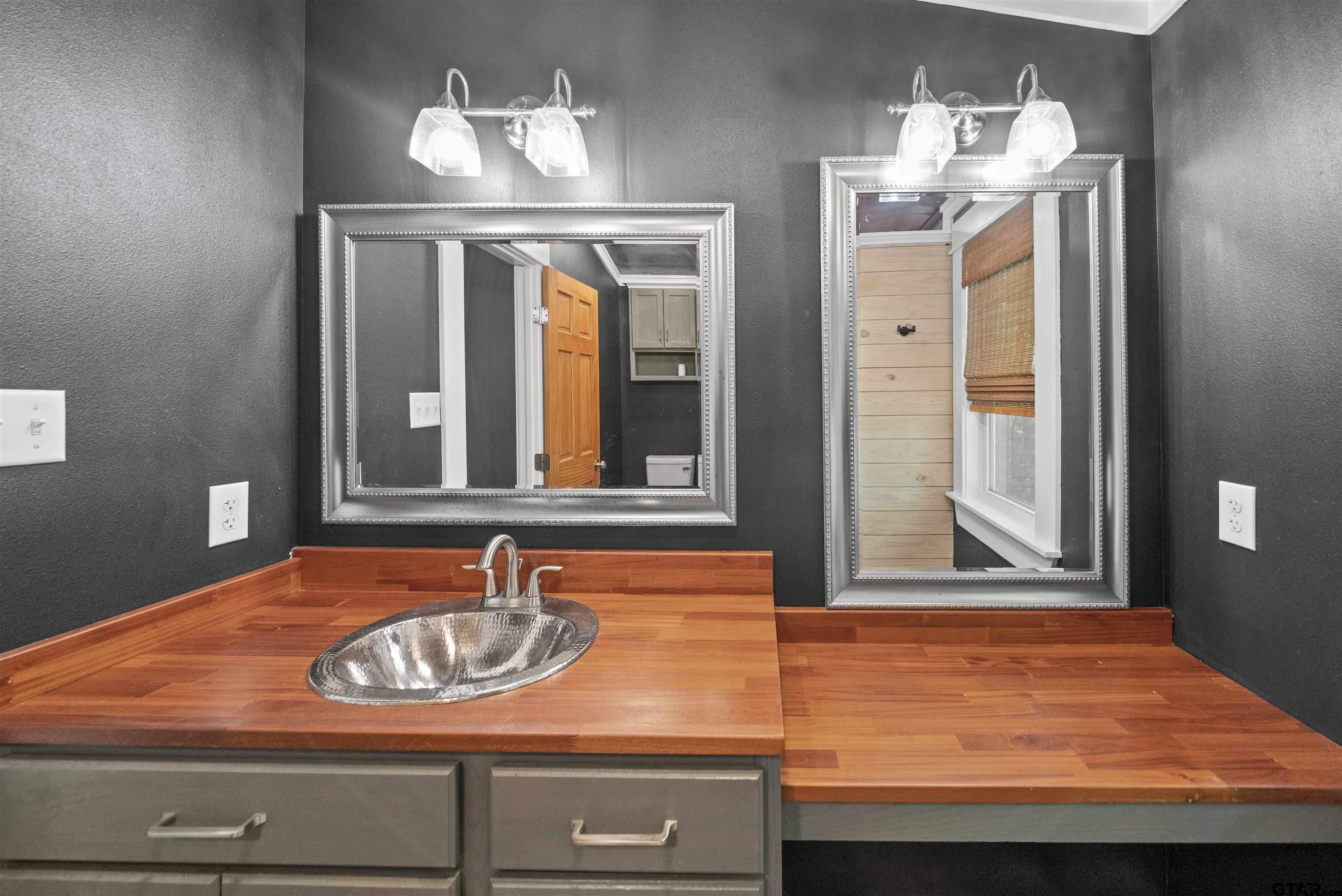 230 North Henderson Street Rusk, TX 75785 - Photo 25 of 34 a bathroom with a sink and a mirror