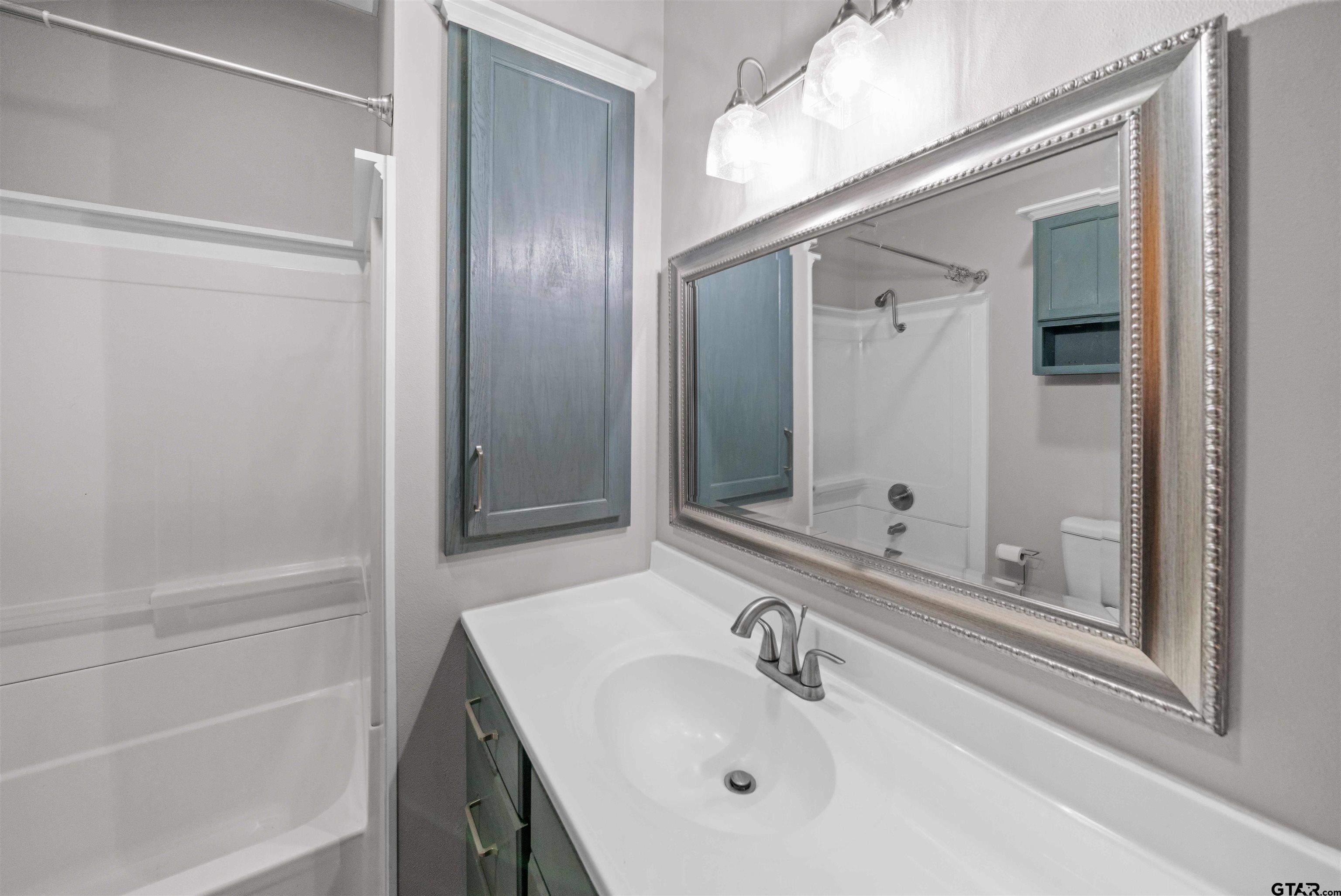 230 North Henderson Street Rusk, TX 75785 - Photo 30 of 34 a bathroom with a sink and a mirror
