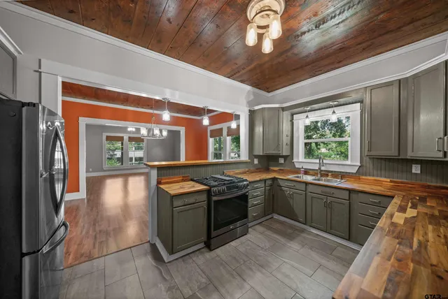 a kitchen with stainless steel appliances granite countertop a stove and a sink