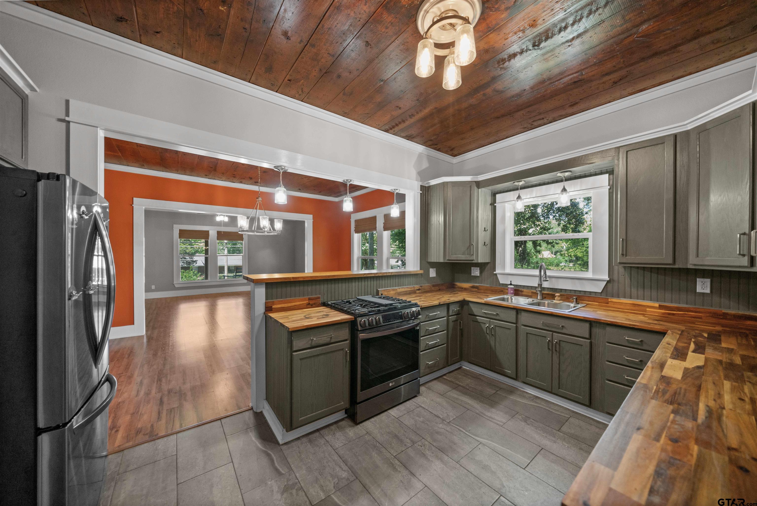 230 North Henderson Street Rusk, TX 75785 - Photo 7 of 34 a kitchen with stainless steel appliances granite countertop a stove and a sink