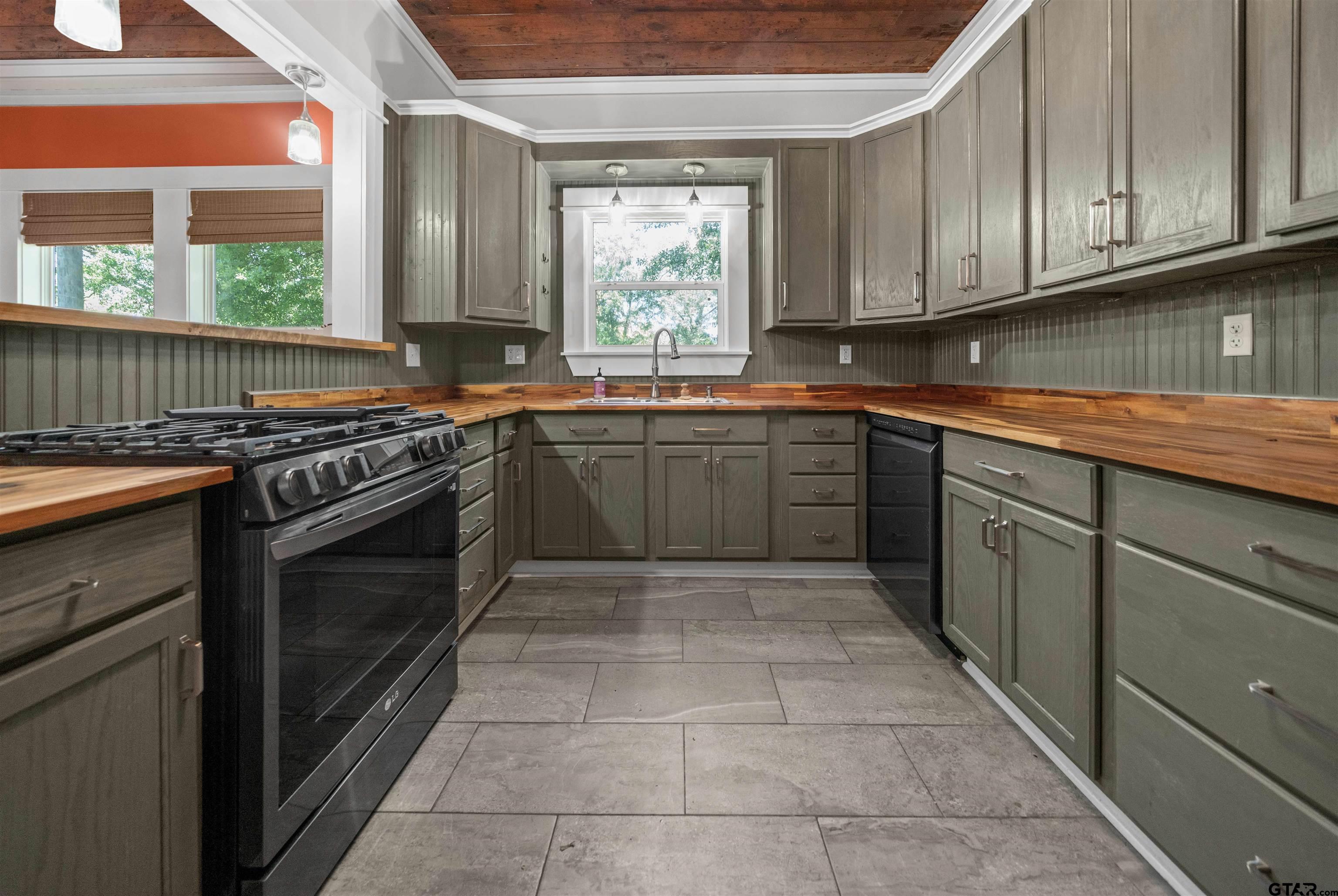230 North Henderson Street Rusk, TX 75785 - Photo 8 of 34 a kitchen with stainless steel appliances granite countertop a stove a sink and a microwave